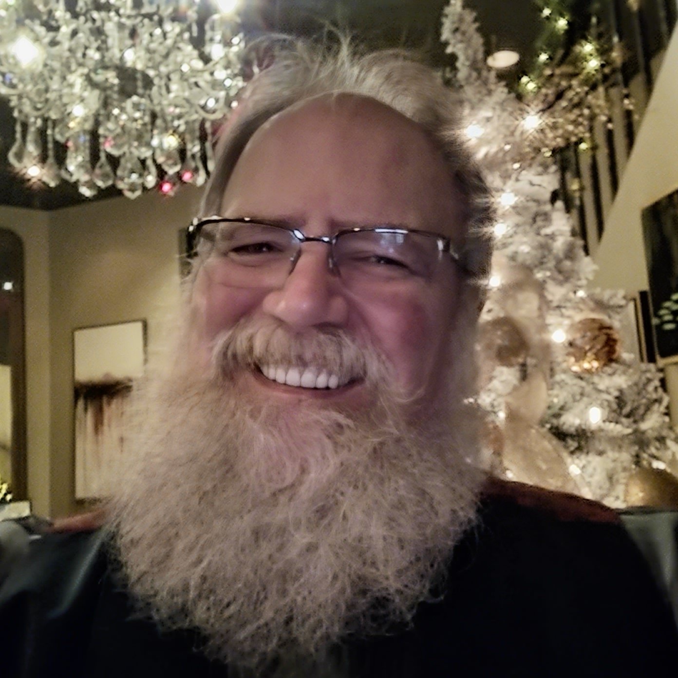Stage Christmas Party — Jeffry grinning under the chandelier by the flocked tree at Stage — from the Christmas collection