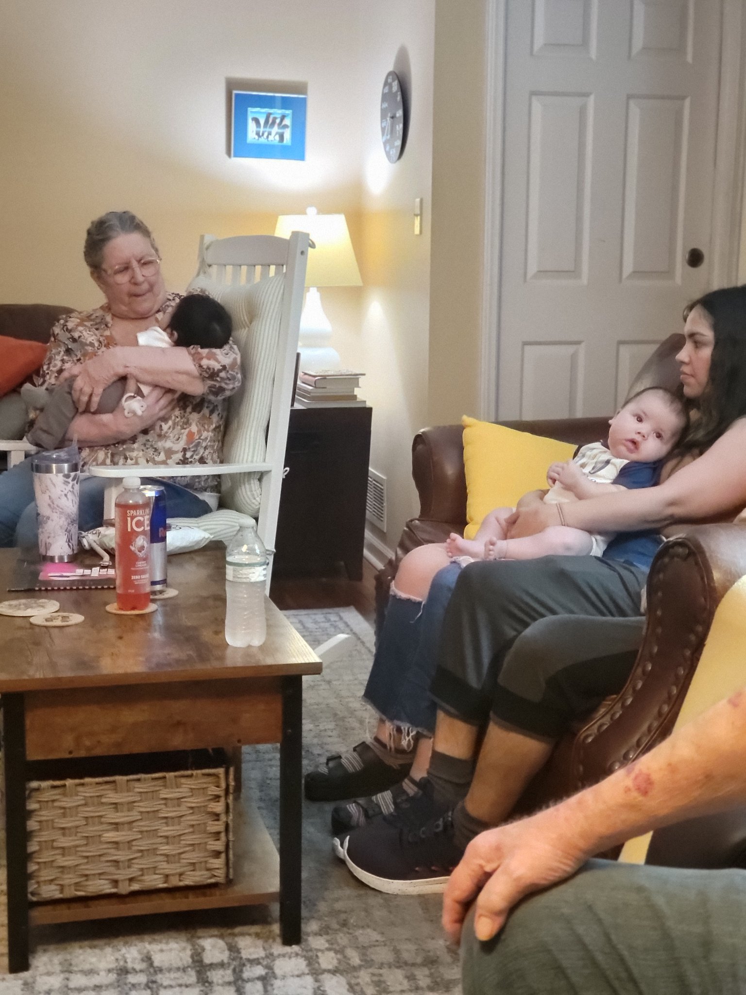 Met my grandchildren for the first time — the living room that day — Gail in the rocking chair cradling a baby, Laura on the couch with the other, Fri · Jul 12, 2024