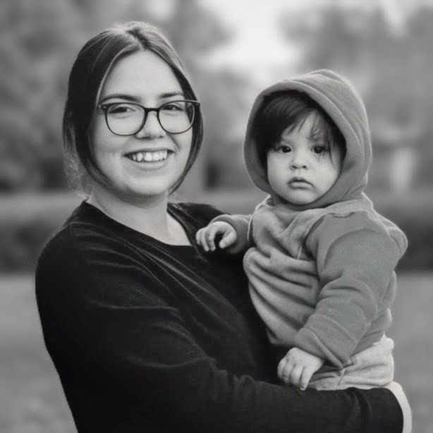 First Halloween trick-or-treating with my grandchildren — a black-and-white portrait of Laura holding her hooded son, Fri · Oct 31, 2025